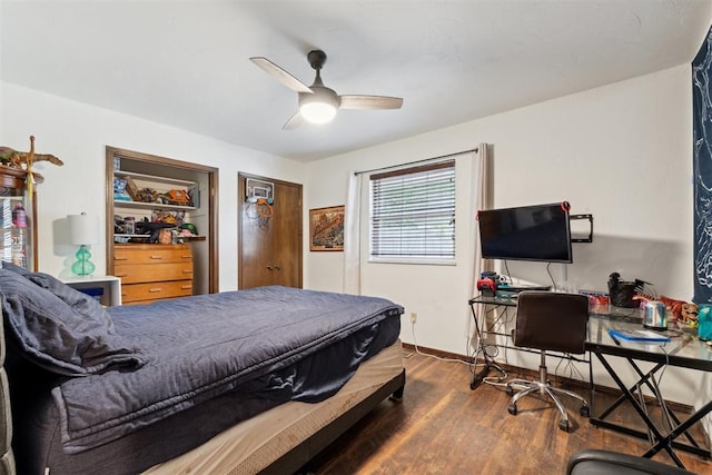 805 John F Kroutil Dr, Yukon, OK 73099 - bedroom featuring dark wood-type flooring, an office area, baseboards, and a ceiling fan