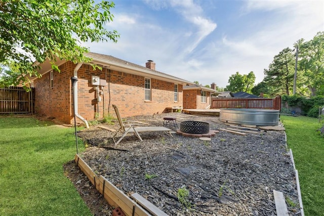 805 John F Kroutil Dr, Yukon, OK 73099 - view of yard featuring a hot tub and an outdoor fire pit