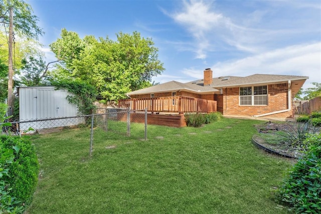 805 John F Kroutil Dr, Yukon, OK 73099 - view of yard featuring a wooden deck, a shed, and an outbuilding