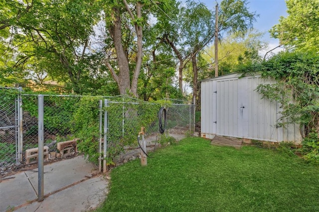 805 John F Kroutil Dr, Yukon, OK 73099 - view of yard featuring a shed, an outbuilding, and a gate