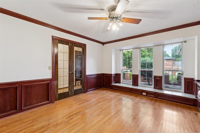 805 John F Kroutil Dr, Yukon, OK 73099 - unfurnished room featuring french doors, wainscoting, light wood finished floors, ceiling fan, and crown molding