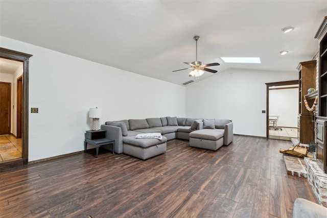 805 John F Kroutil Dr, Yukon, OK 73099 - living area with dark wood-style flooring, a ceiling fan, lofted ceiling, and a skylight