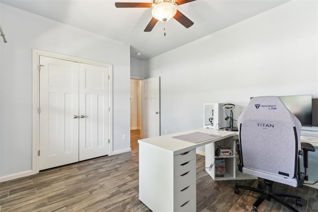 home office featuring wood finished floors, a ceiling fan, and baseboards