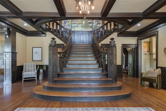1415 N Hudson Ave, Oklahoma City, OK 73103 - stairs featuring coffered ceiling, ornamental molding, beam ceiling, wood finished floors, and a chandelier