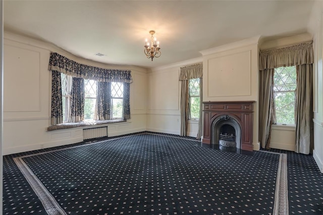 1415 N Hudson Ave, Oklahoma City, OK 73103 - unfurnished living room featuring dark carpet, radiator heating unit, a chandelier, baseboards, and a fireplace