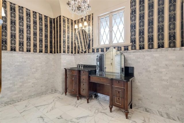 1415 N Hudson Ave, Oklahoma City, OK 73103 - bathroom featuring a chandelier, vanity, marble finish flooring, and tile walls
