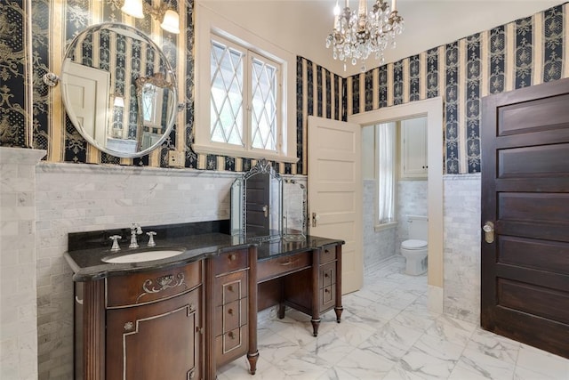 1415 N Hudson Ave, Oklahoma City, OK 73103 - bathroom with vanity, wallpapered walls, toilet, a chandelier, and marble finish floors