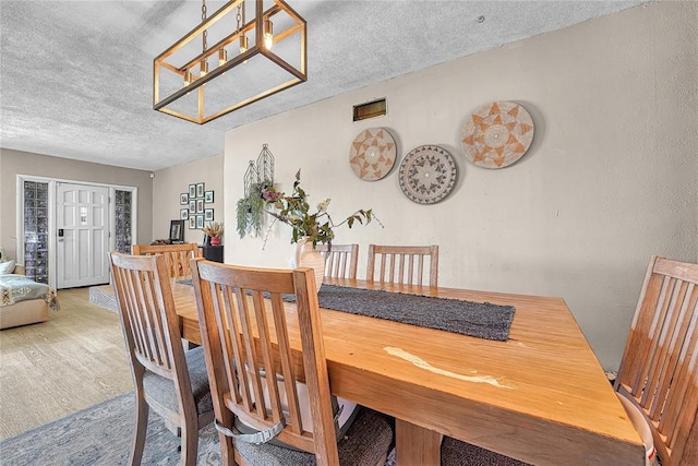 800 N Main St, Thomas, OK 73669 - dining room with a textured ceiling and wood finished floors