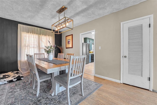 800 N Main St, Thomas, OK 73669 - dining space featuring a chandelier, light wood-style flooring, and baseboards