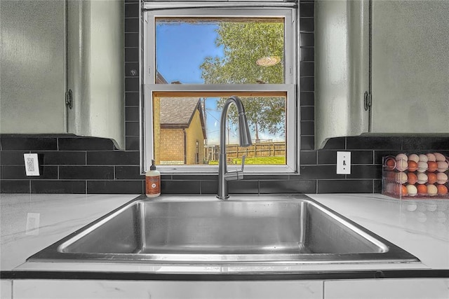 800 N Main St, Thomas, OK 73669 - kitchen view of a sink, tasteful backsplash, and light countertops