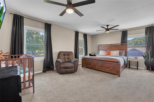800 N Main St, Thomas, OK 73669 - carpeted bedroom with multiple windows, baseboards, and ceiling fan