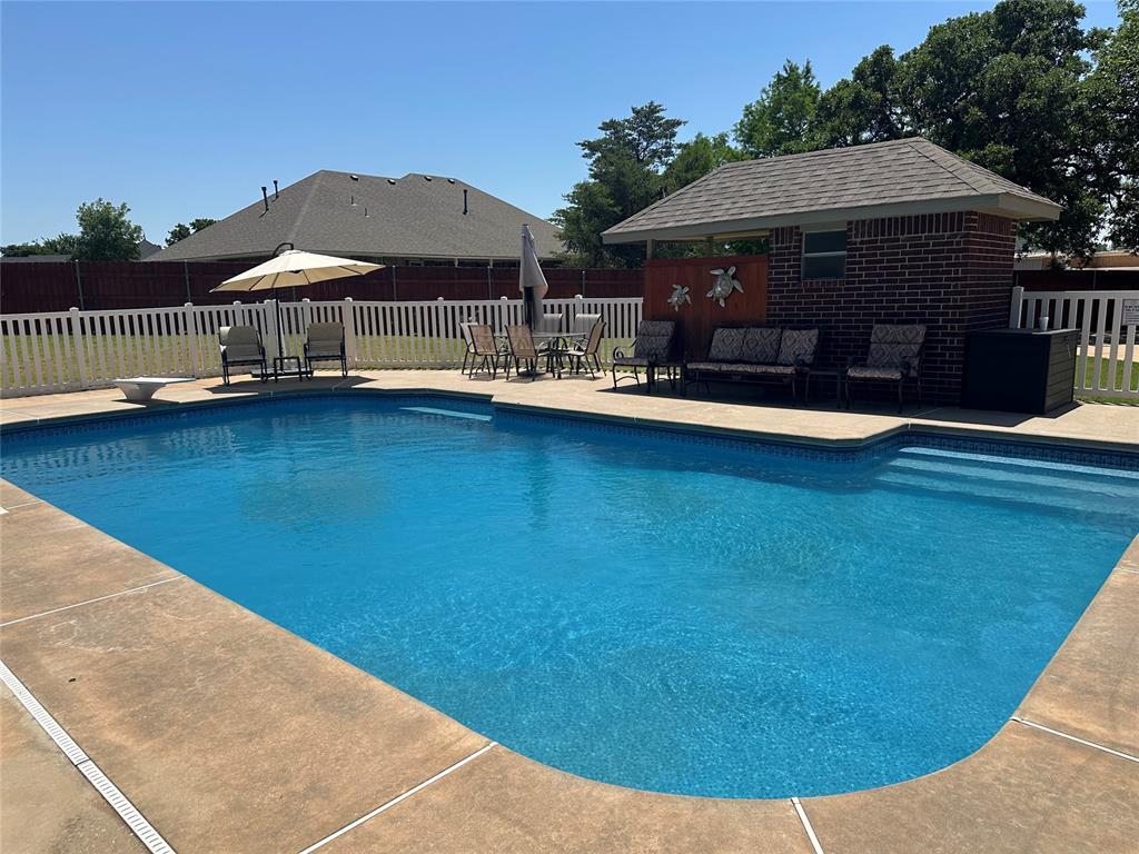 606 Cypress Ct, Blanchard, OK 73010 - view of pool featuring an outdoor structure, a patio area, outdoor lounge area, a diving board, and outdoor dining area