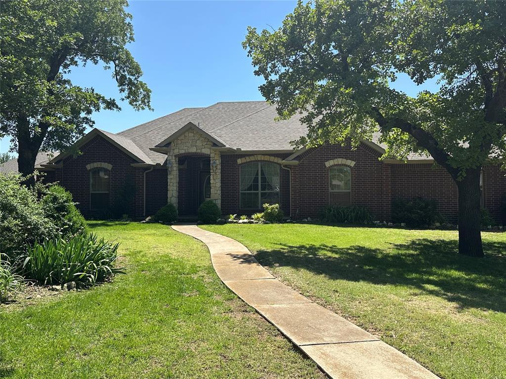 606 Cypress Ct, Blanchard, OK 73010 - french provincial home featuring a front lawn, brick siding, and stone siding