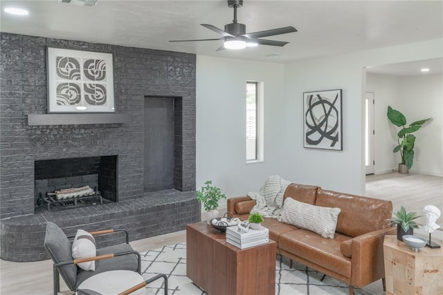 6212 N Utah Ave, Oklahoma City, OK 73112 - living room with a fireplace, a ceiling fan, and light wood-type flooring