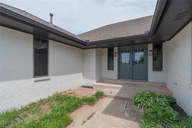6212 N Utah Ave, Oklahoma City, OK 73112 - doorway to property with brick siding and a shingled roof
