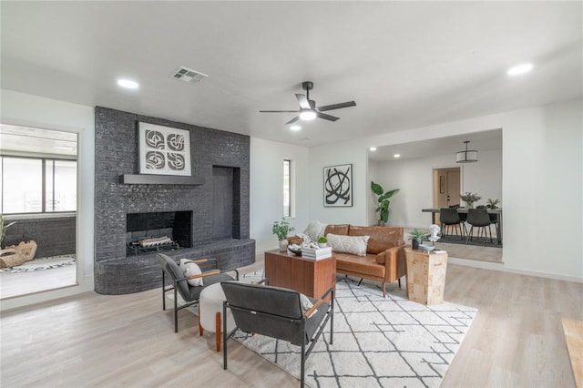 6212 N Utah Ave, Oklahoma City, OK 73112 - living room featuring plenty of natural light, light wood-style floors, ceiling fan, a large fireplace, and recessed lighting