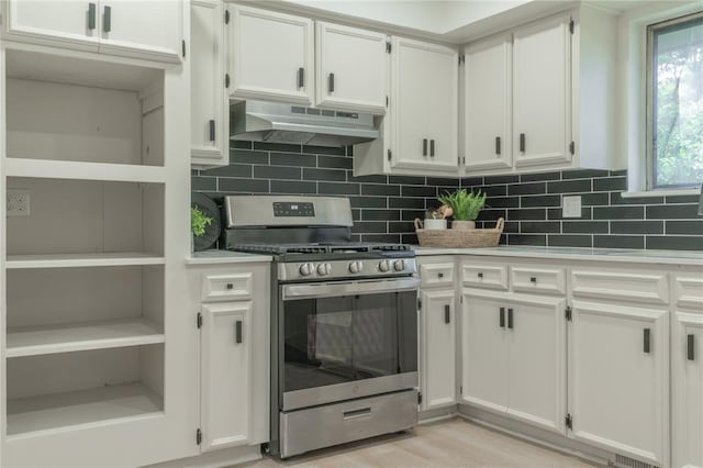 6212 N Utah Ave, Oklahoma City, OK 73112 - kitchen with stainless steel gas range, under cabinet range hood, white cabinetry, and tasteful backsplash