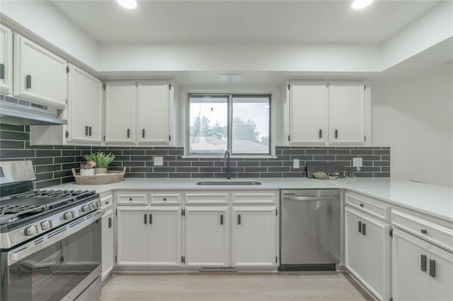 6212 N Utah Ave, Oklahoma City, OK 73112 - kitchen with stainless steel appliances, a sink, white cabinetry, light countertops, and recessed lighting