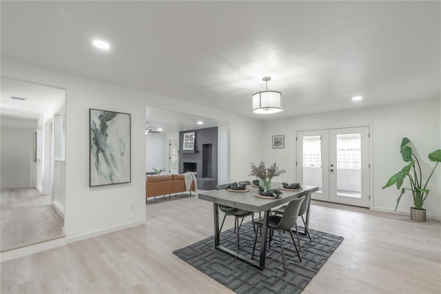 6212 N Utah Ave, Oklahoma City, OK 73112 - dining room featuring light wood-style flooring, a fireplace, french doors, baseboards, and recessed lighting