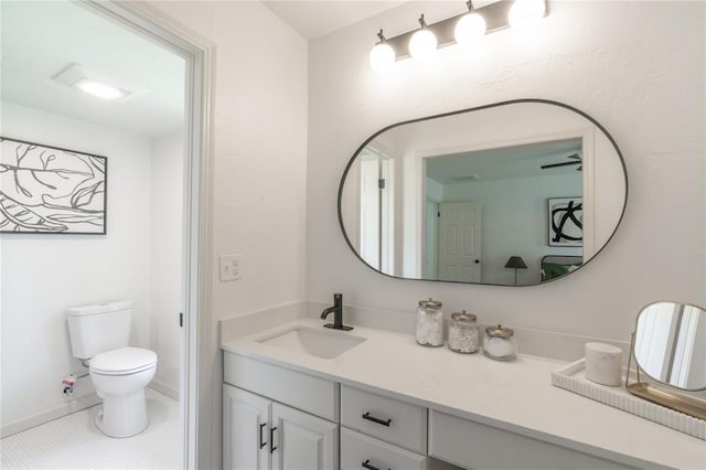 6212 N Utah Ave, Oklahoma City, OK 73112 - bathroom featuring toilet, vanity, tile patterned flooring, and baseboards