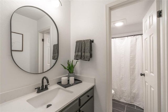 6212 N Utah Ave, Oklahoma City, OK 73112 - bathroom with vanity, toilet, tile patterned flooring, and a shower with shower curtain