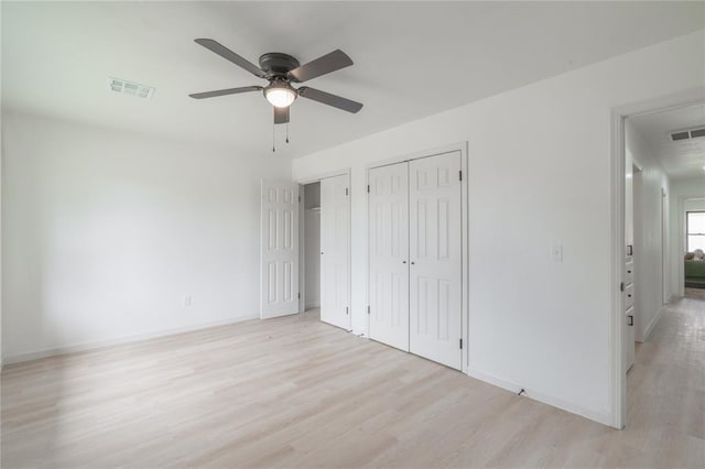 6212 N Utah Ave, Oklahoma City, OK 73112 - unfurnished bedroom featuring light wood-type flooring, baseboards, ceiling fan, and multiple closets