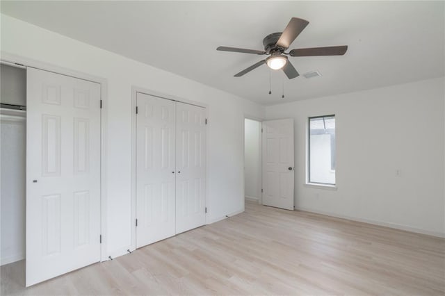 6212 N Utah Ave, Oklahoma City, OK 73112 - unfurnished bedroom with light wood-style flooring, baseboards, multiple closets, and ceiling fan