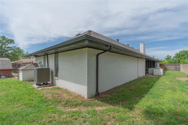 6212 N Utah Ave, Oklahoma City, OK 73112 - view of property exterior featuring central AC, brick siding, and a chimney