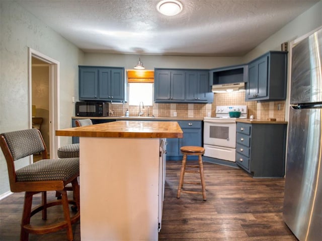 164 4th St, Faxon, OK 73540 - kitchen with white electric stove, butcher block countertops, freestanding refrigerator, blue cabinetry, and black microwave