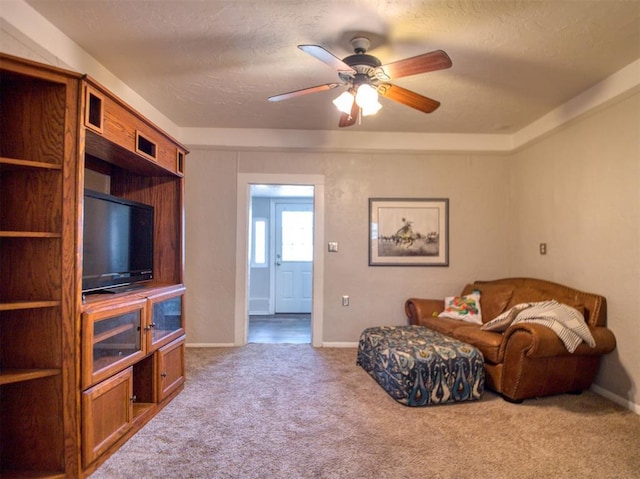 164 4th St, Faxon, OK 73540 - living area with carpet flooring, ceiling fan, baseboards, and a textured ceiling