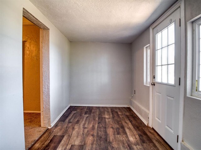 164 4th St, Faxon, OK 73540 - empty room with wood finished floors, a textured ceiling, baseboards, and a textured wall