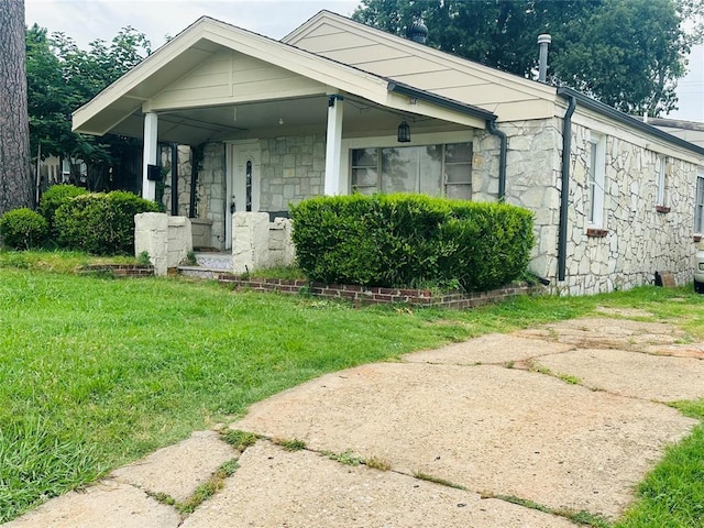 209 SW 40th St, Oklahoma City, OK 73109 - bungalow-style house featuring stone siding and a front lawn