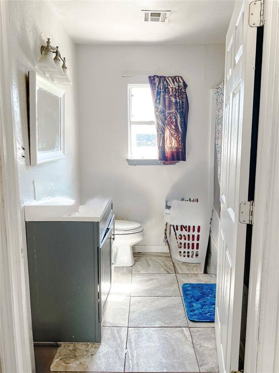 209 SW 40th St, Oklahoma City, OK 73109 - bathroom featuring vanity and toilet