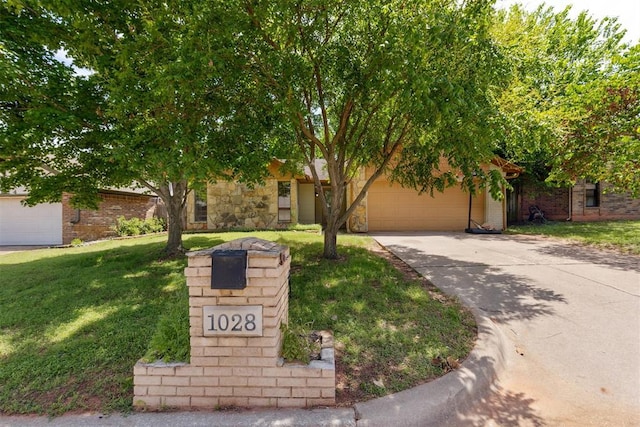 view of property hidden behind natural elements with concrete driveway, a garage, and a front yard