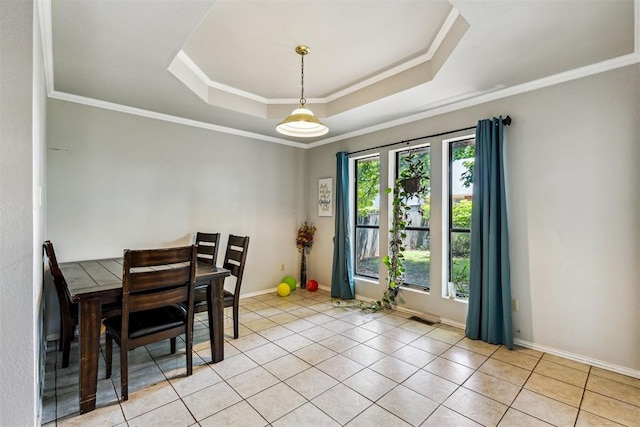 dining space with a tray ceiling, crown molding, light tile patterned flooring, and baseboards