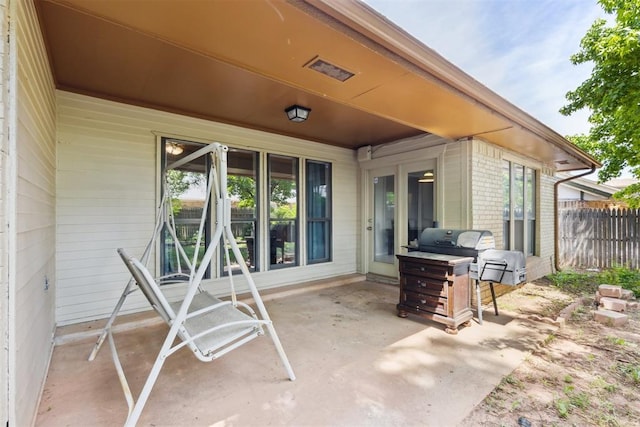 view of patio featuring fence and grilling area