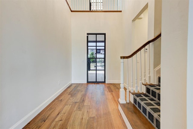 4209 Las Colinas Ln, Norman, OK 73072 - entrance foyer with a towering ceiling, wood-type flooring, stairway, and baseboards