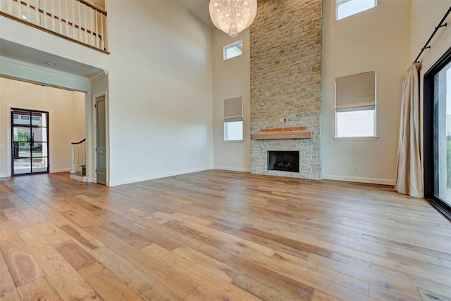 4209 Las Colinas Ln, Norman, OK 73072 - unfurnished living room with a high ceiling, wood-type flooring, a chandelier, and plenty of natural light