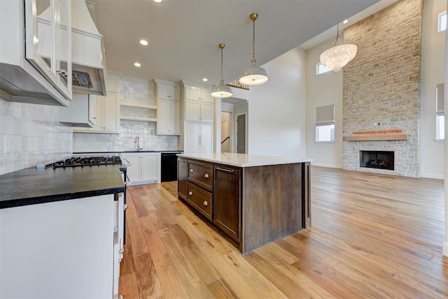 4209 Las Colinas Ln, Norman, OK 73072 - kitchen featuring healthy amount of natural light, dark brown cabinetry, white cabinetry, a towering ceiling, and tasteful backsplash