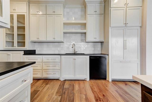 4209 Las Colinas Ln, Norman, OK 73072 - kitchen featuring black dishwasher, a sink, dark countertops, light wood-style floors, and decorative backsplash