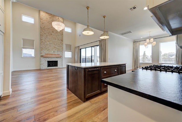 4209 Las Colinas Ln, Norman, OK 73072 - kitchen featuring a chandelier, dark brown cabinetry, healthy amount of natural light, and ornamental molding