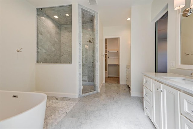 4209 Las Colinas Ln, Norman, OK 73072 - bathroom featuring a shower stall, vanity, baseboards, a spacious closet, and a freestanding tub