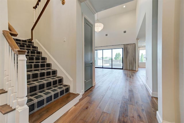 4209 Las Colinas Ln, Norman, OK 73072 - stairs featuring wood-type flooring, a towering ceiling, and baseboards
