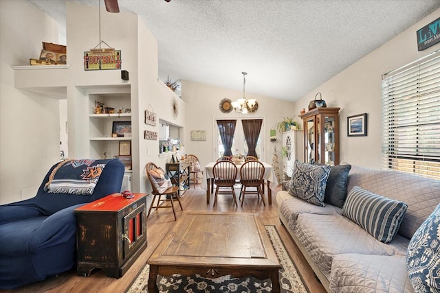 6104 Westlane, Oklahoma City, OK 73142 - living room featuring wood finished floors, a textured ceiling, a chandelier, lofted ceiling, and built in shelves