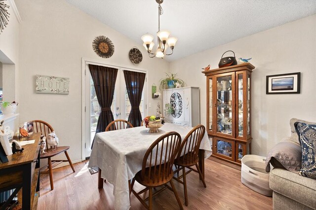 6104 Westlane, Oklahoma City, OK 73142 - dining area featuring a chandelier, lofted ceiling, and light wood-type flooring