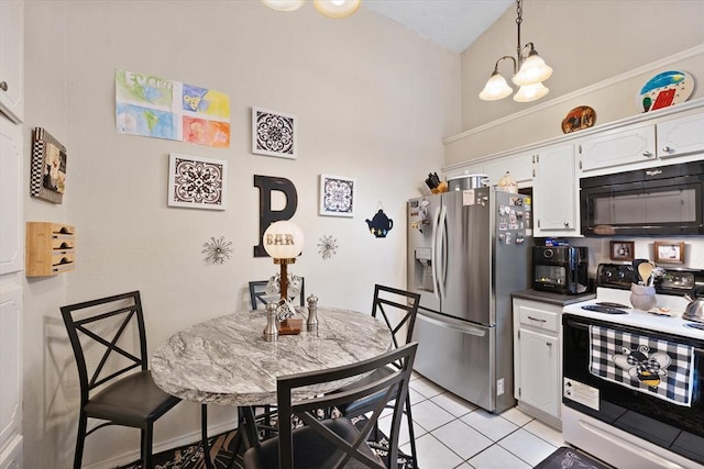 6104 Westlane, Oklahoma City, OK 73142 - kitchen featuring black microwave, range with electric stovetop, stainless steel fridge, and white cabinets