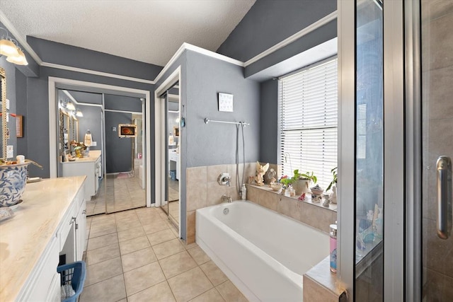 6104 Westlane, Oklahoma City, OK 73142 - full bath featuring vanity, tile patterned flooring, a garden tub, a textured ceiling, and a shower