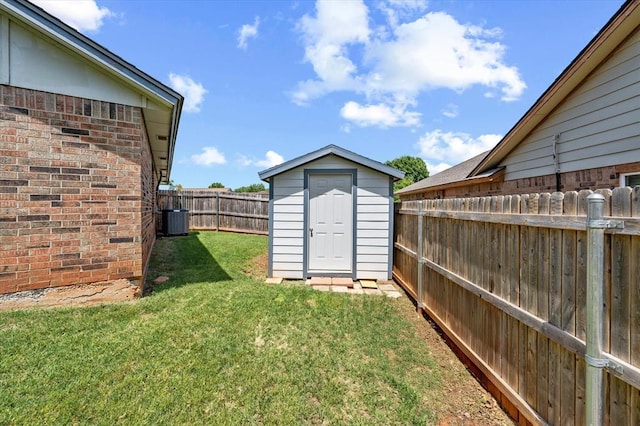 6104 Westlane, Oklahoma City, OK 73142 - view of yard featuring cooling unit, a storage shed, and an outbuilding