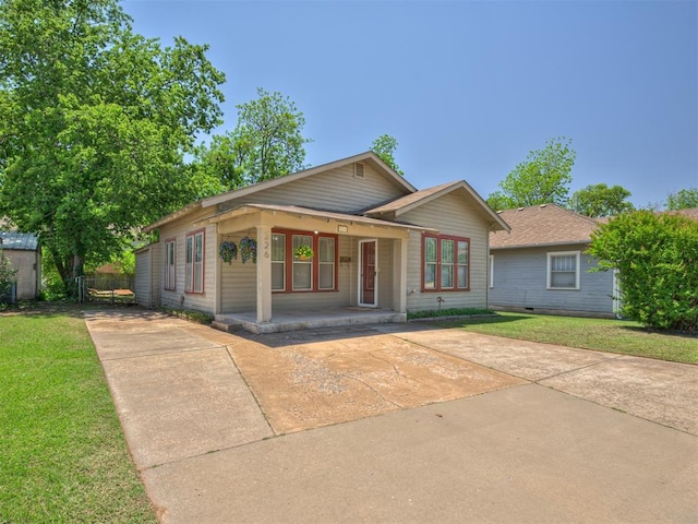 view of front of house featuring a front lawn, a porch, and concrete driveway