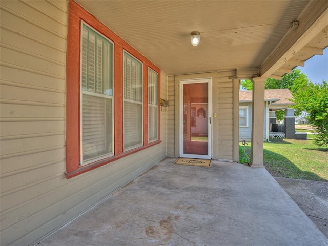 property entrance with a patio area and a yard